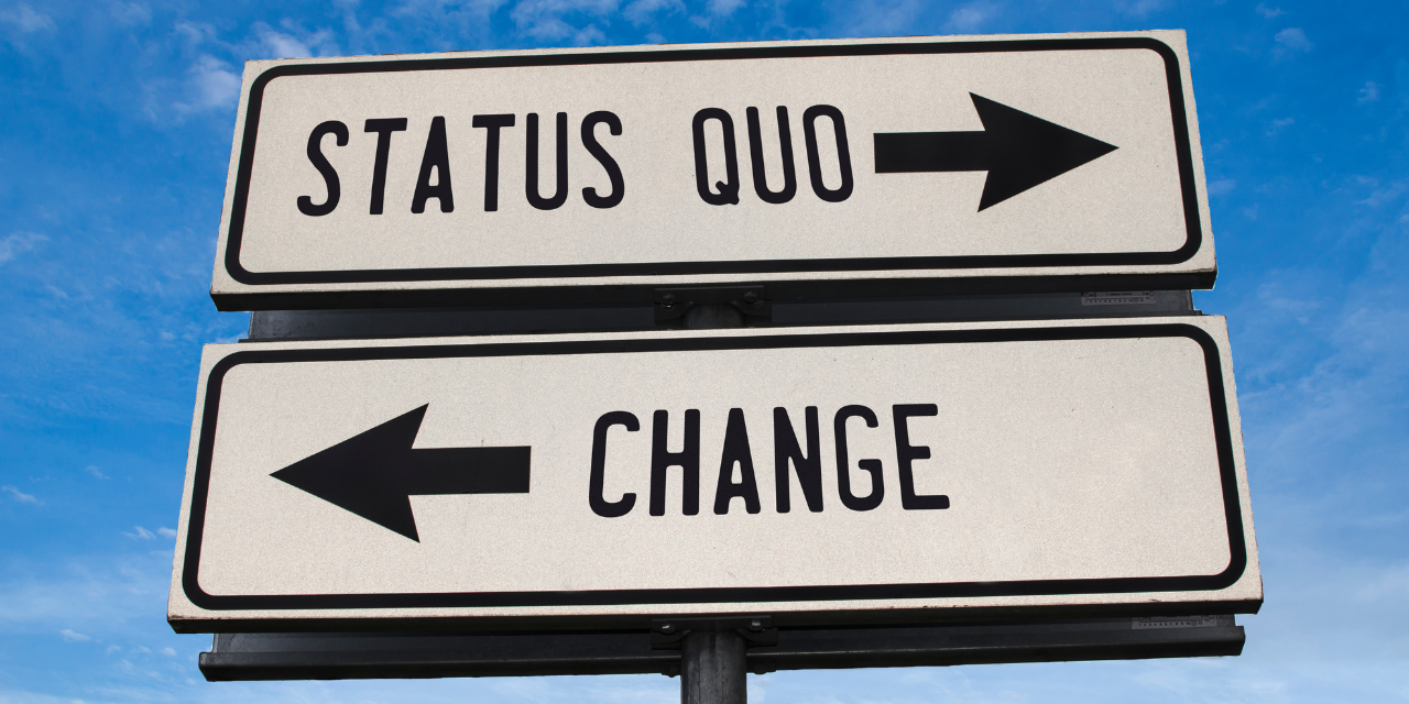 A sign with the words "Status Quo" and an arrow point to the right, and the word "Change" and an arrow pointing to the left.