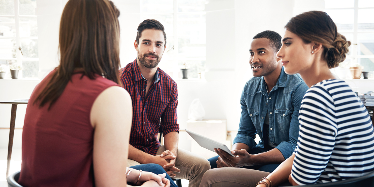 Four people sitting and having a conversation.