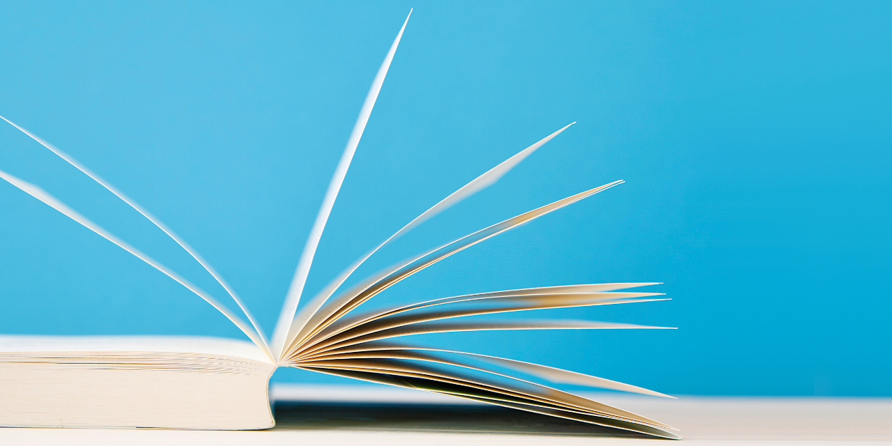 open book on blue background. reading, education, literature, learning and back to school concept